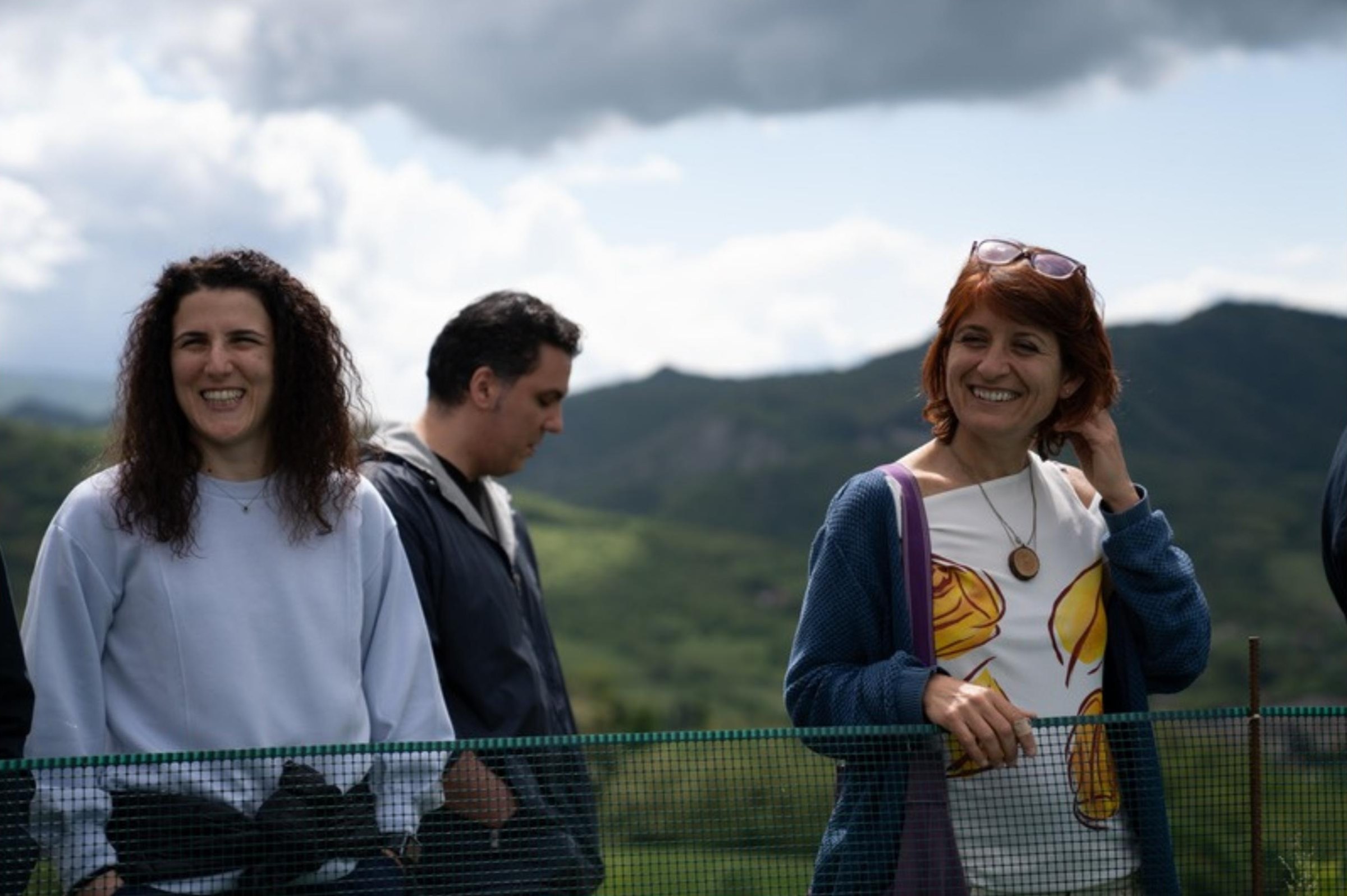 Partecipanti in cammino in montagna, sorridenti