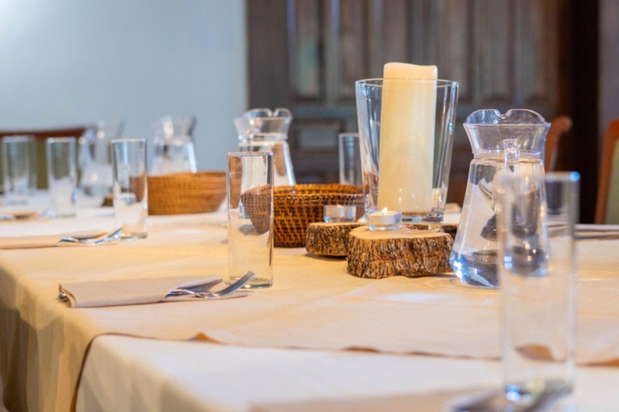 La mesa puesta, con velas y vasos, lista para la cena