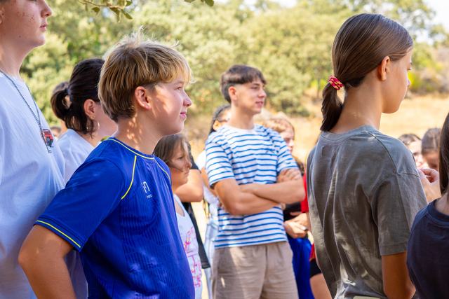 Chicos y chicas escuchan al aire libre en la finca