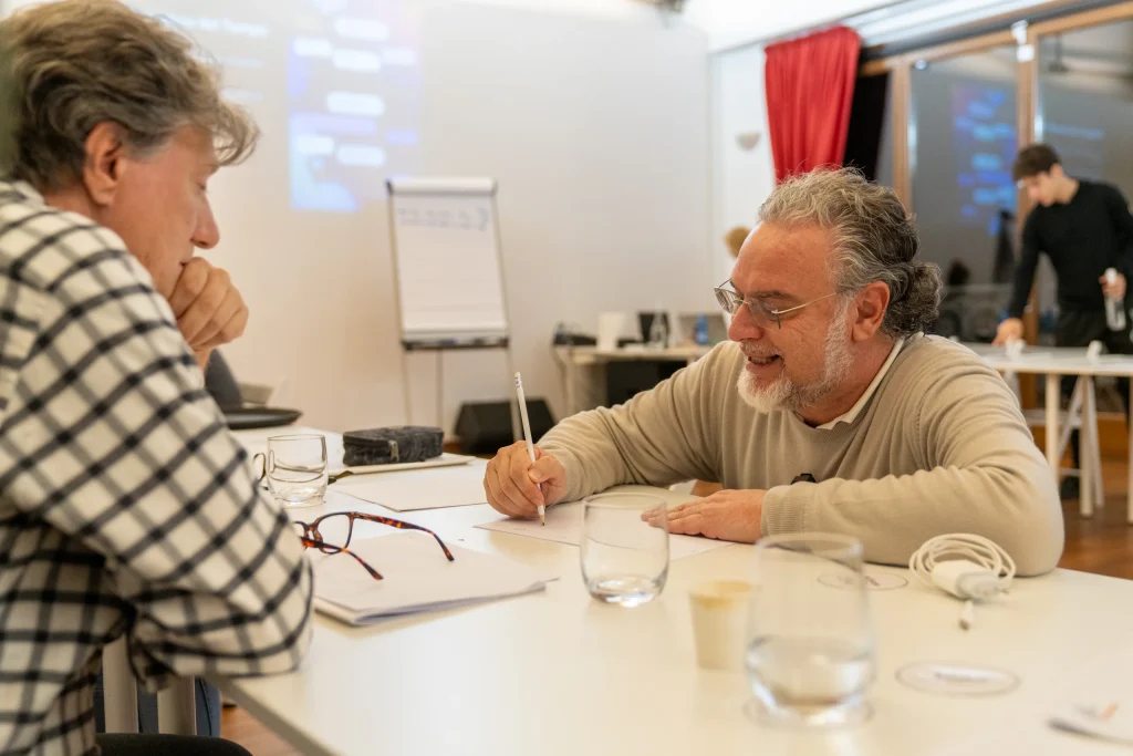 A participant writing during a table discussion