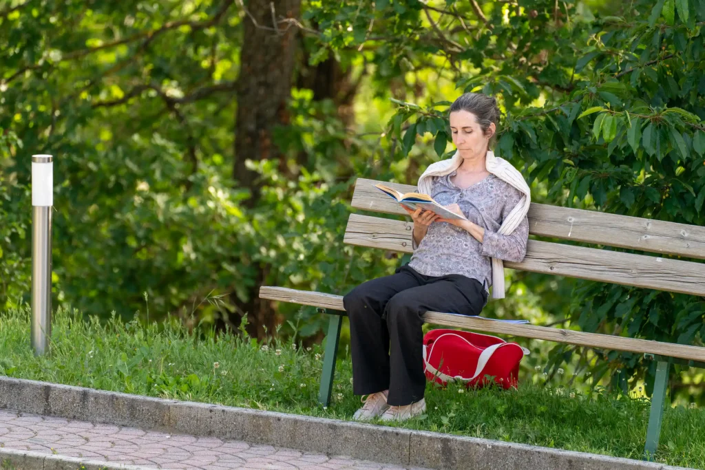 A participant reading on a park bench